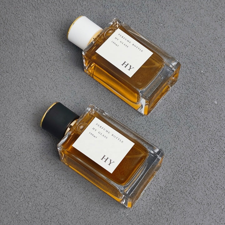 Wholesale 100ml Simple Thick Rectangle Glass Perfume Bottle with Gold Top and Black/White Round Cap Pump Sprayer Sealing Type