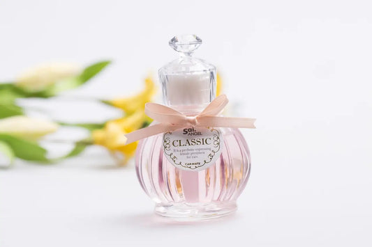 Perfume bottle decorated with personalized label and pink ribbon