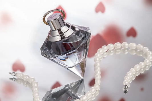 Diamond shaped glass perfume bottle with electroplated cap