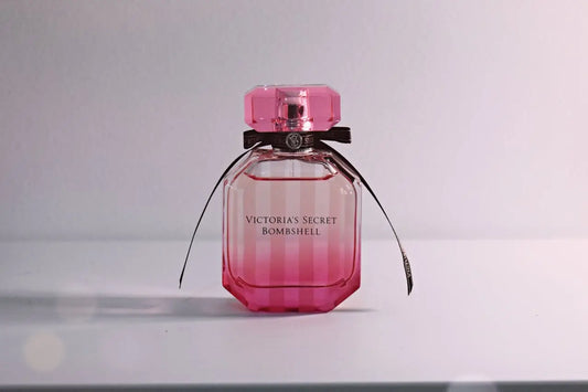 Victoria's Secret Bombshell perfume bottle on white surface