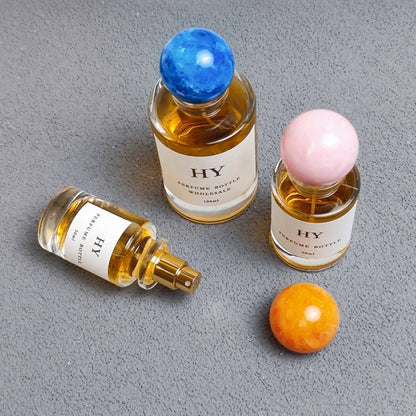 Wholesale Beautiful Neck Design 30ml 50ml 100ml Round Glass Luxury OUD Perfume Bottles with Colorful Resin Cap