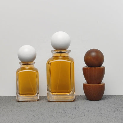 Luxury Unique Square Design 50ml 100ml Arabic Perfume Bottles with Crimp Atomizer and Wood Cap Screen Printing