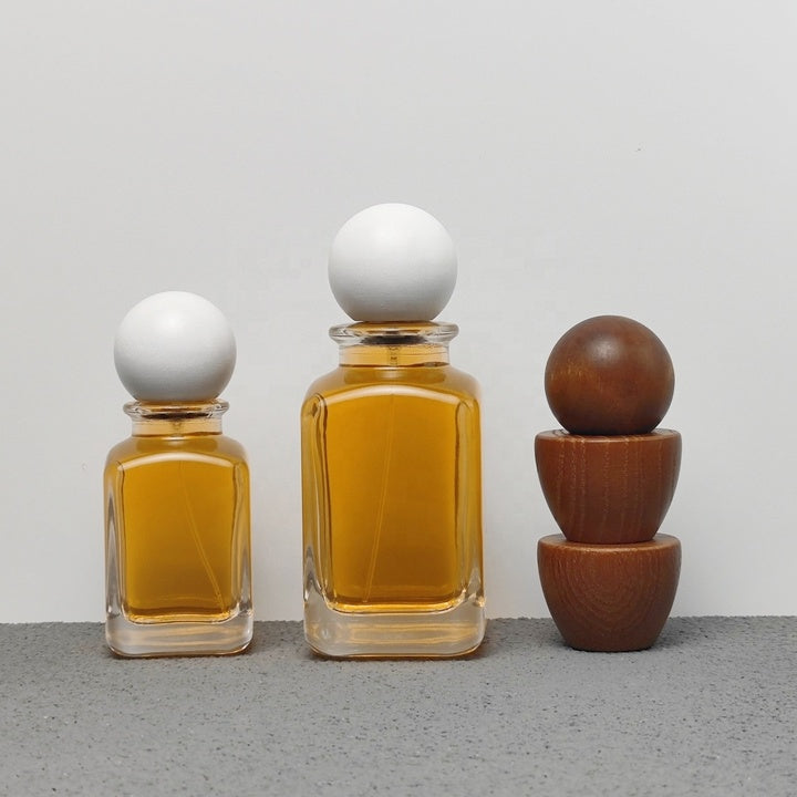 Luxury Unique Square Design 50ml 100ml Arabic Perfume Bottles with Crimp Atomizer and Wood Cap Screen Printing