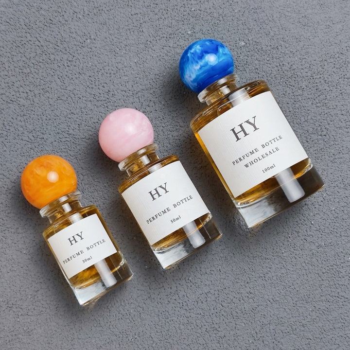 Wholesale Beautiful Neck Design 30ml 50ml 100ml Round Glass Luxury OUD Perfume Bottles with Colorful Resin Cap