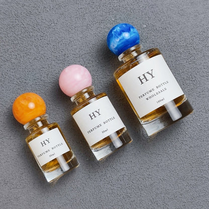 Wholesale Beautiful Neck Design 30ml 50ml 100ml Round Glass Luxury OUD Perfume Bottles with Colorful Resin Cap