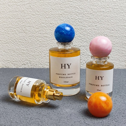 Wholesale Beautiful Neck Design 30ml 50ml 100ml Round Glass Luxury OUD Perfume Bottles with Colorful Resin Cap