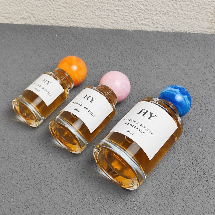 Wholesale Beautiful Neck Design 30ml 50ml 100ml Round Glass Luxury OUD Perfume Bottles with Colorful Resin Cap