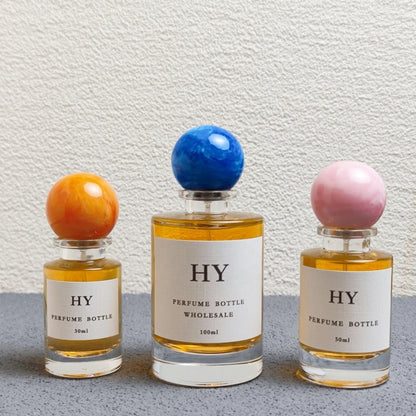 Wholesale Beautiful Neck Design 30ml 50ml 100ml Round Glass Luxury OUD Perfume Bottles with Colorful Resin Cap