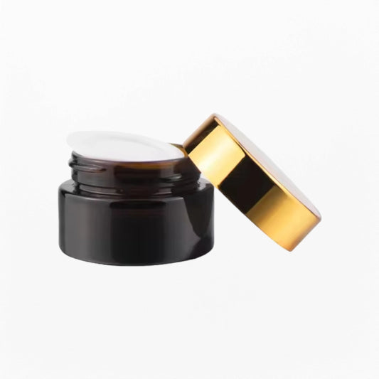 A cosmetic cream jar with gold lid