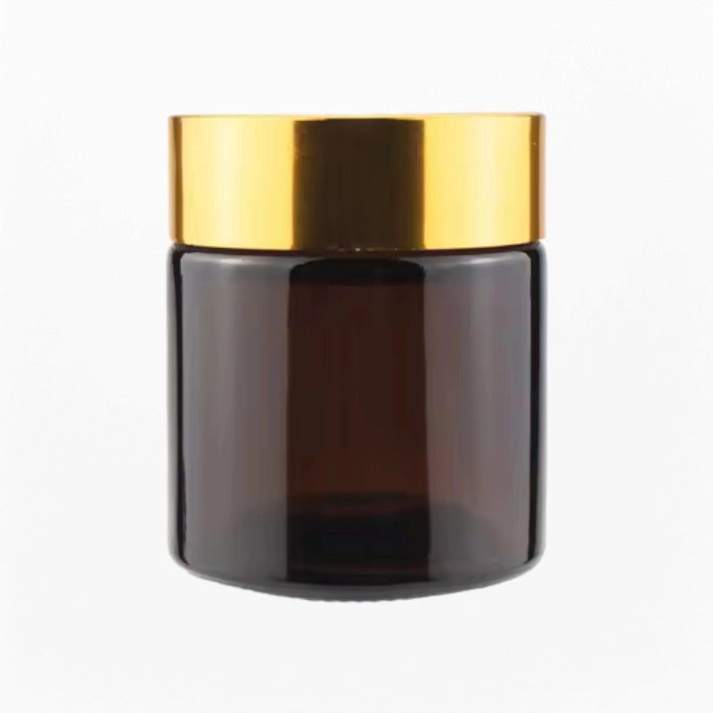 A cosmetic cream jar with gold cap