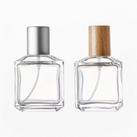 two cube perfume bottles with silver and wood cap