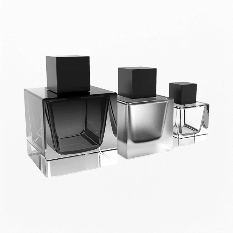 three cube perfume bottles with different black colors and black caps