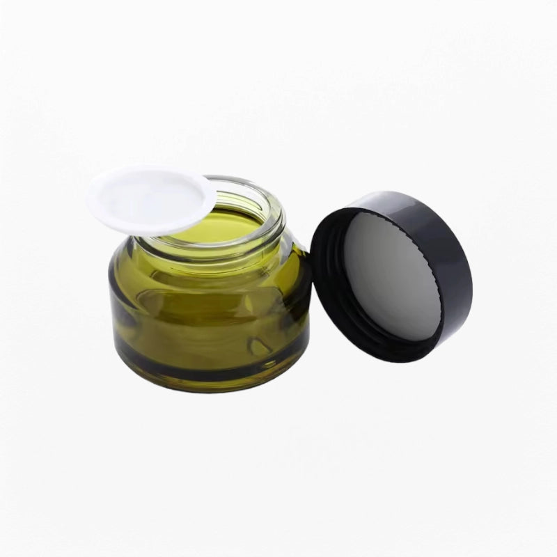Empty cosmetic jar olive-green glass with black lid