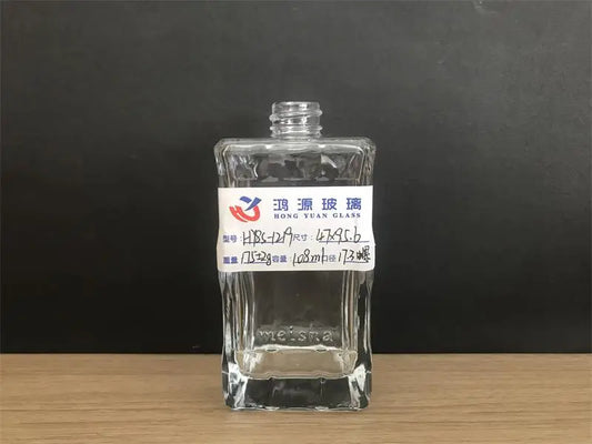empty glass lotion bottle with unique lines