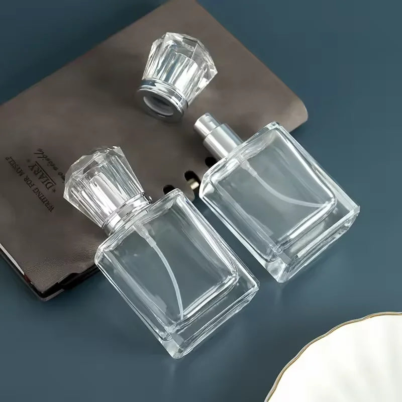 Two empty perfume bottles lying on a notebook
