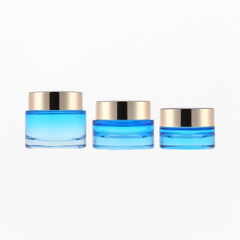 3 blue cream jars of different sizes