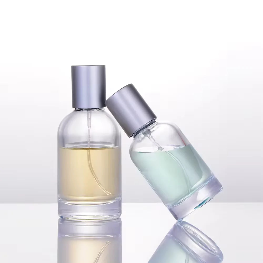 2 sizes of cylindrical perfume bottles with silver caps