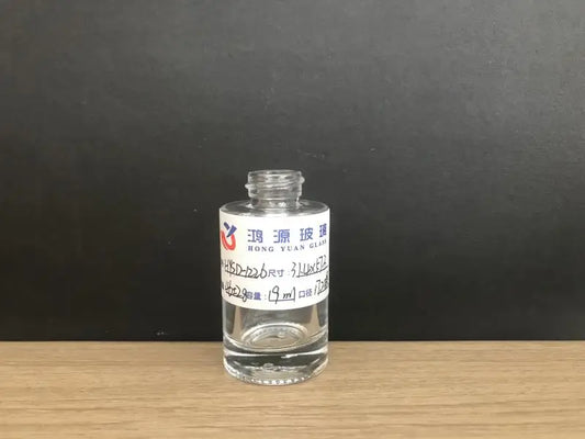 small round lotion bottle made by clear glass