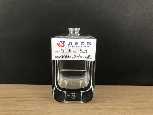 A 100 ml glass perfume bottle with square  shape